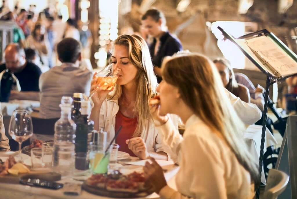 food safety compliance, woman eating and drinking in a restaurant
